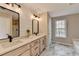 Modern bathroom featuring double sinks, quartz countertops, and wood-look tile flooring at 591 Paper Ridge Ct, Lawrenceville, GA 30046