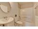 Well-lit bathroom with white subway tile, pedestal sink, toilet and shower/tub combo at 591 Paper Ridge Ct, Lawrenceville, GA 30046