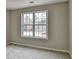 A simple, carpeted bedroom featuring a large window for natural light at 591 Paper Ridge Ct, Lawrenceville, GA 30046