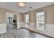 Spacious room with wood-look floors, wainscoting, and two windows offering abundant natural light at 591 Paper Ridge Ct, Lawrenceville, GA 30046