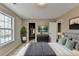 Comfortable bedroom with soft carpet and an open closet with an organized wardrobe at 591 Paper Ridge Ct, Lawrenceville, GA 30046