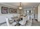 This bright dining room boasts stylish decor and flows seamlessly into the living area at 591 Paper Ridge Ct, Lawrenceville, GA 30046