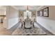 Elegant dining room with wainscoting, modern chandelier, and seating for six at 591 Paper Ridge Ct, Lawrenceville, GA 30046
