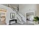 Elegant two-story foyer with staircase, artwork, and wood-look flooring creating a welcoming entrance at 591 Paper Ridge Ct, Lawrenceville, GA 30046