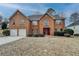 Charming two-story brick home with a well-manicured lawn and a two-car garage at 591 Paper Ridge Ct, Lawrenceville, GA 30046