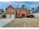Charming two-story brick home with a well-manicured lawn and a two-car garage at 591 Paper Ridge Ct, Lawrenceville, GA 30046