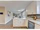 Bright kitchen features white cabinets, modern hardware, stainless steel appliances, and an island at 591 Paper Ridge Ct, Lawrenceville, GA 30046