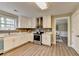 Bright kitchen with stainless steel appliances, white cabinetry, and hardwood floors at 591 Paper Ridge Ct, Lawrenceville, GA 30046