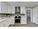 Modern kitchen with stainless steel oven, white cabinets, and stylish backsplash at 591 Paper Ridge Ct, Lawrenceville, GA 30046