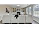 Bright living room with fireplace, built-in shelves, white sofa and wood-look flooring at 591 Paper Ridge Ct, Lawrenceville, GA 30046
