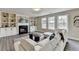 Spacious living room with a cozy fireplace and built-in shelves, perfect for relaxing or entertaining guests at 591 Paper Ridge Ct, Lawrenceville, GA 30046