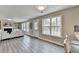 Bright living room with fireplace, built-in shelves, white sofa and wood-look flooring at 591 Paper Ridge Ct, Lawrenceville, GA 30046