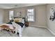 Spacious main bedroom with plush carpet, neutral walls, and bright windows at 591 Paper Ridge Ct, Lawrenceville, GA 30046