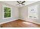 Bright bedroom with hardwood floors, two large windows, neutral walls, and modern ceiling fan at 2081 Verbena Nw St, Atlanta, GA 30314
