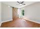 Spacious bedroom featuring hardwood floors, a ceiling fan, and a stylish barn door at 2081 Verbena Nw St, Atlanta, GA 30314