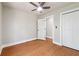 Bedroom with hardwood floors, neutral walls, a modern ceiling fan, and closet with bi-fold doors at 2081 Verbena Nw St, Atlanta, GA 30314