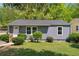 Charming home featuring new gray siding, a well manicured lawn and manicured shrubbery at 2081 Verbena Nw St, Atlanta, GA 30314