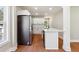 Modern kitchen with stainless steel appliances, island and stylish wood flooring at 2081 Verbena Nw St, Atlanta, GA 30314