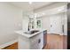 Bright kitchen with quartz countertops, island with seating, and stainless steel dishwasher at 2081 Verbena Nw St, Atlanta, GA 30314