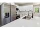 Bright, modern kitchen featuring stainless steel appliances, quartz countertops, and white cabinetry at 2081 Verbena Nw St, Atlanta, GA 30314