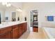 Bathroom with double vanity and an open doorway to the bedroom at 2124 Marshalls Se Ln, Atlanta, GA 30316