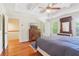 Bedroom with hardwood floors, dresser, and a door leading to the hallway at 2124 Marshalls Se Ln, Atlanta, GA 30316