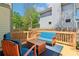 Inviting wooden deck features stylish blue cushioned seating and a natural wood railing and fenced backyard at 2124 Marshalls Se Ln, Atlanta, GA 30316