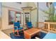 Inviting wooden deck features stylish blue cushioned seating and a natural wood railing and fenced backyard at 2124 Marshalls Se Ln, Atlanta, GA 30316