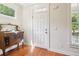 Bright entryway featuring a white door, classic trim, and a vintage wooden cabinet at 2124 Marshalls Se Ln, Atlanta, GA 30316
