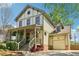 Charming two-story home with a front porch, well-manicured lawn, and a garage at 2124 Marshalls Se Ln, Atlanta, GA 30316