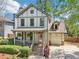 Charming two-story home with a front porch, a well-manicured lawn, and a garage at 2124 Marshalls Se Ln, Atlanta, GA 30316