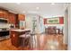 Open kitchen and dining area with stainless steel appliances, an island, and hardwood floors at 2124 Marshalls Se Ln, Atlanta, GA 30316