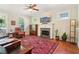 Bright living room featuring a fireplace, hardwood floors, and views to the outside and kitchen at 2124 Marshalls Se Ln, Atlanta, GA 30316