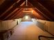 Attic space featuring exposed wooden beams, bare walls and small window at 3013 Barcelona Way, Conyers, GA 30012