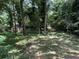 A lush, green backyard with mature trees and a shed, offering a private and serene setting at 3013 Barcelona Way, Conyers, GA 30012