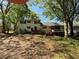 View of the two-story home's exterior featuring a back deck, screened in porch and spacious backyard at 3013 Barcelona Way, Conyers, GA 30012