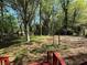 Spacious backyard featuring mature trees, a wooden fence, and an outbuilding, viewed from the back deck at 3013 Barcelona Way, Conyers, GA 30012