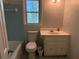 Bathroom with blue tiled shower, white vanity and commode at 3013 Barcelona Way, Conyers, GA 30012
