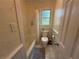 Bathroom with tub, toilet, shower curtain and window at 3013 Barcelona Way, Conyers, GA 30012