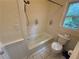 Clean bathroom with a shower-tub combo, tiled floor, and natural lighting at 3013 Barcelona Way, Conyers, GA 30012