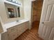 Bathroom vanity with drawers, a mirror, and a walk-in closet access at 3013 Barcelona Way, Conyers, GA 30012