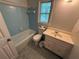 Cozy bathroom features a blue tiled wall above the bathtub and a tiled floor at 3013 Barcelona Way, Conyers, GA 30012
