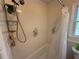 Bathroom tub and shower with floral shower curtain and floral tile at 3013 Barcelona Way, Conyers, GA 30012