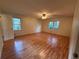 Large bedroom featuring hardwood floors, a ceiling fan, and natural light at 3013 Barcelona Way, Conyers, GA 30012
