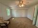 Spacious bedroom featuring ceiling fan and a chair in the corner at 3013 Barcelona Way, Conyers, GA 30012