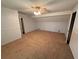 Spacious carpeted bedroom with large windows, a ceiling fan, and two closets at 3013 Barcelona Way, Conyers, GA 30012
