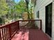 Red wooden deck overlooking a green backyard, adding outdoor living space at 3013 Barcelona Way, Conyers, GA 30012