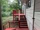 Exterior view of a red deck and stairs leading down to the backyard at 3013 Barcelona Way, Conyers, GA 30012