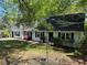 One-story home featuring white siding, dark roof, landscaped yard at 3013 Barcelona Way, Conyers, GA 30012