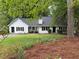 Charming one-story home with white siding, black shutters, and a well-manicured lawn at 3013 Barcelona Way, Conyers, GA 30012